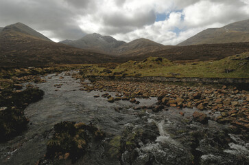 mountain stream with Cuillins in background, Isle of Skye, Scotland UK