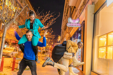 Doing a piggyback ride together and having a great time together outisde