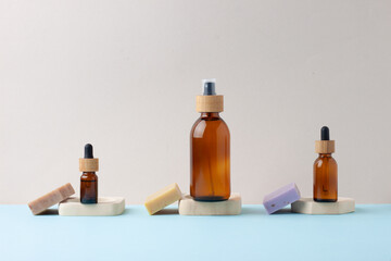 Cosmetic skin care products with soap on grey, blue background. Close up, copy space