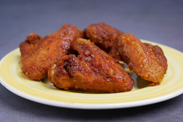 chicken wings on a plate on black background 