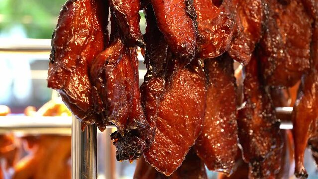 Fresh char siew and roast duck on the display window of Cantonese roast pork shop