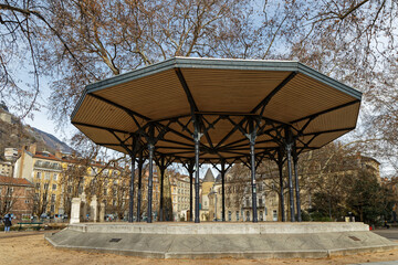 GRENOBLE, FRANCE, February 3, 2022 : Kiosk in the Jardin de Ville park (city garden) and Hotel de Lesdigui&egrave;res, ancient City Hall until 1967.