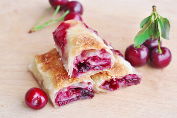 Delicious Homemade Cherry Pie.Sweet slices of cherry strudel on a wooden table. Traditional cuisine. 
