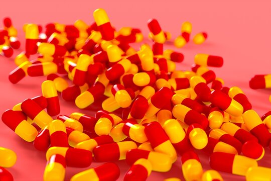 yellow and red pharmaceuticals drugs capsules 3D computer generated illustration