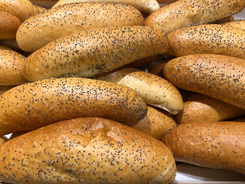 Long white bread rolls with poppy seeds