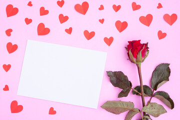 White greeting card , red heart papercut and red rose on pink background