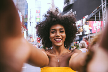 Cinematic portraits of a beautiful american young woman with curly hair in New york. Concept about...