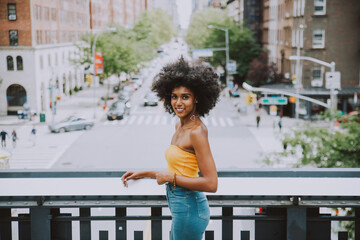 Cinematic portraits of a beautiful american young woman with curly hair in New york. Concept about new yorkers lifestyle and people - obrazy, fototapety, plakaty