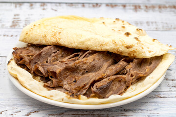 Doner kebab on a wooden background. Traditional Turkish cuisine flavor meat doner.