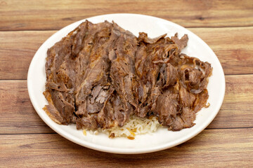 Doner kebab on a wooden background. Traditional Turkish cuisine flavor meat doner. Local name...
