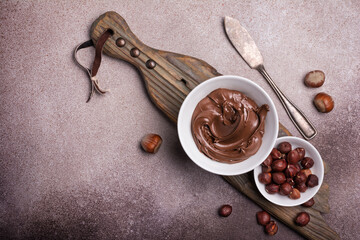 Tasty chocolate cream or sweet nut butter with whole hazelnuts