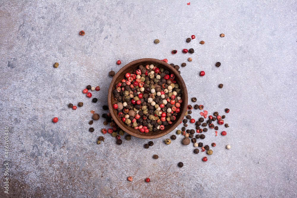 Wall mural bowl of bright pepper spices for tasty cooking