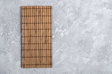 Asian bamboo mat on grey concrete