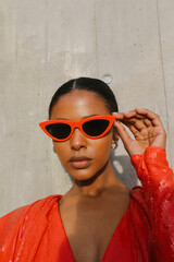 Portrait of beautiful African American woman wears sunglasses posing outdoor.