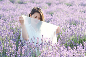 Beautiful Asian young woman model in spring or summer lavender field, Chinese girl enjoy her time...