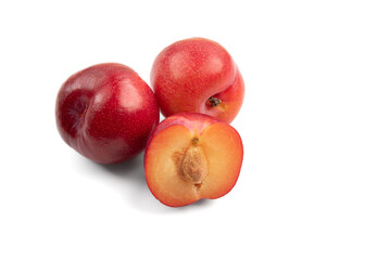Fototapeta na wymiar horizontal photo of plums, one cut in half showing the stone. isolated on a white background with copy space
