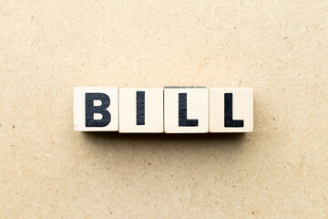 Alphabet letter block in word bill on wood background