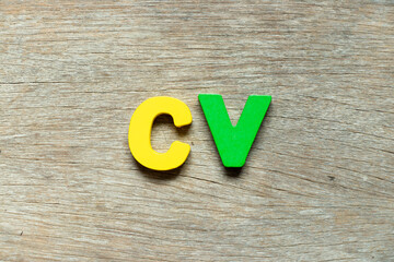 Color alphabet letter in word CV (Abbreviation of curriculum vitae) on wood background