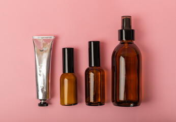 Set of cosmetic products on a pink background.Collection of cosmetic packaging for cream, scrub,...