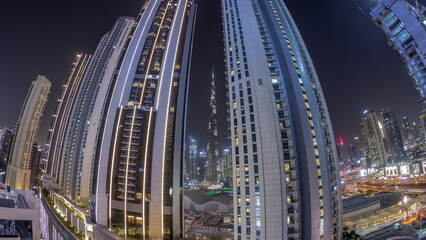 Fototapeta na wymiar Tallest skyscrapers in downtown dubai located on bouleward street near shopping mall aerial night timelapse.