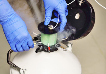 Dewar vessel with liquid nitrogen with frozen embryos and eggs in a cryobank in a modern IVF clinic. Reproductive medicine, in vitro fertilization - obrazy, fototapety, plakaty