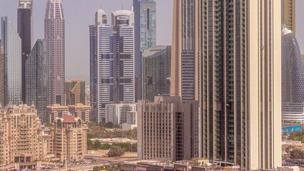 Fototapeta na wymiar Row of the tall buildings around Sheikh Zayed Road and DIFC district aerial all day timelapse in Dubai