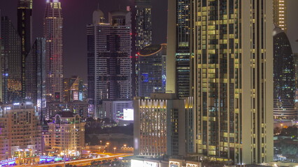 Fototapeta na wymiar Row of the tall buildings around Sheikh Zayed Road and DIFC district aerial night timelapse in Dubai