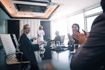 Fototapeta na wymiar Cinematic image of a multiethnic business team working together in Dubai in offices. Concept about finance, investments and real estate market