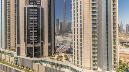 Tallest skyscrapers in downtown dubai located on bouleward street near shopping mall aerial all day timelapse.