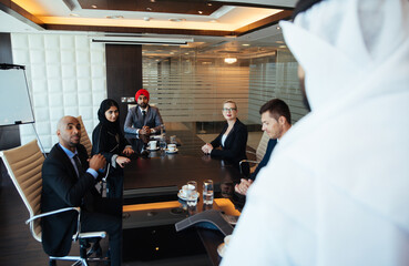 Cinematic image of a multiethnic business team working together in Dubai in offices. Concept about finance, investments and real estate market