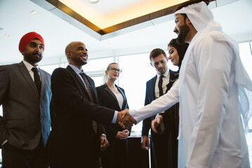 Cinematic image of a multiethnic business team working together in Dubai in offices. Concept about finance, investments and real estate market