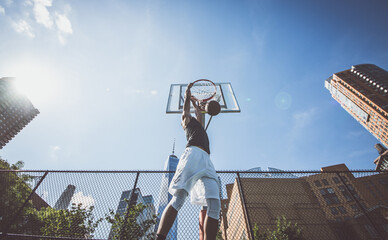 Huge slam dunk. Two basketball players playing hard on the court. Street basketball challenge in...