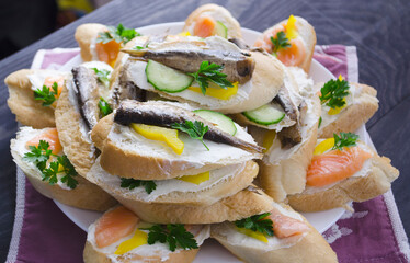Sandwich, sandwich with salmon and sprats on a plate. Macro background. High quality photo. Banquet.