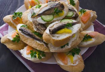 Sandwich, sandwich with salmon and sprats on a plate. Macro background. High quality photo. Banquet.
