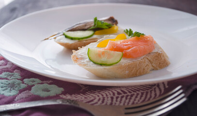 Sandwich, sandwich with salmon and sprats on a plate. Macro background. High quality photo. Banquet.