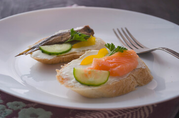 Sandwich, sandwich with salmon and sprats on a plate. Macro background. High quality photo. Banquet.