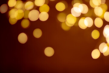 Defocused bokeh on a brown background from above.