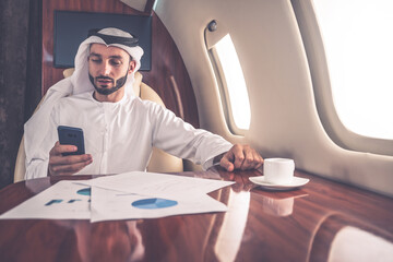Business man from united arab emirates flying on his private jet to Dubai.  Successful speaker salesman and entrepreneur going to his meeting convention