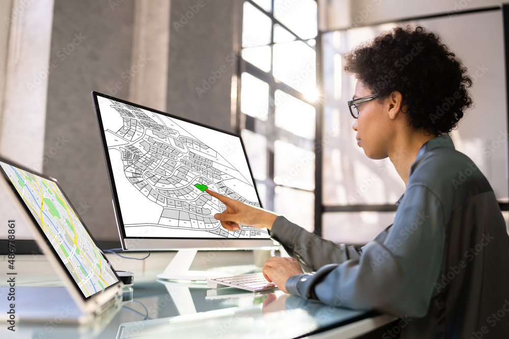 Poster businessperson analyzing cadastre map on computer