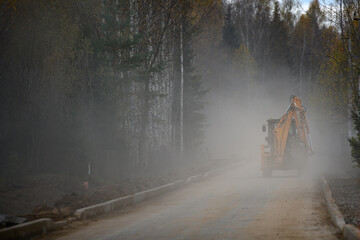 Excavator on the country road, Moscow Region, Russia