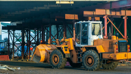 Motor grader on road construction. Orange bulldozer on bridge road construction site. Detour. Road Closed.