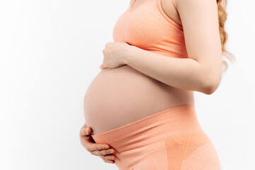 pregnant woman touching her belly on a white background. Woman expecting a baby, happy pregnant...