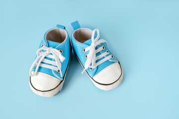 Baby's little shoes on a colorful background. The concept of waiting for a baby and the concept of...