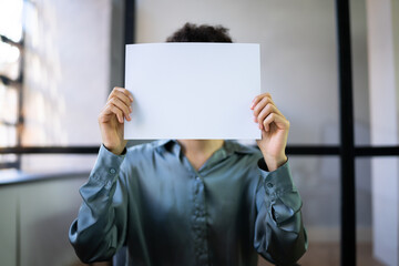 Businesswoman Holding Empty Paper In Front Of Face