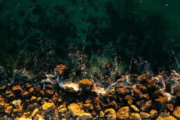 Aerial view of an amazing sunset at the seaside. Seashore landscape with turquoise water color and...
