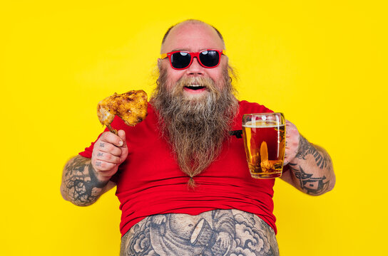 Man watching television while drinking and eating. Funny hipster man portrait on a colored background
