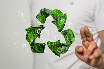 hand holding green recycle symbol
