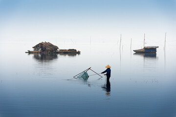 Fisherman in a lake of vietnam- blue serenity Zen