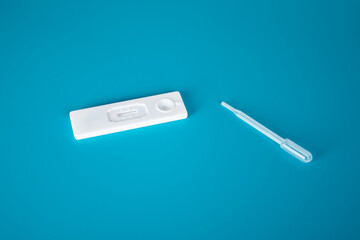 lateral flow test, blood cassette and pipette on blue medical background