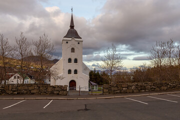 Fototapeta na wymiar View of the Midvagur Church in small village on Vagar island. Leitisvegur, Sandavagur, Faroe Islands.